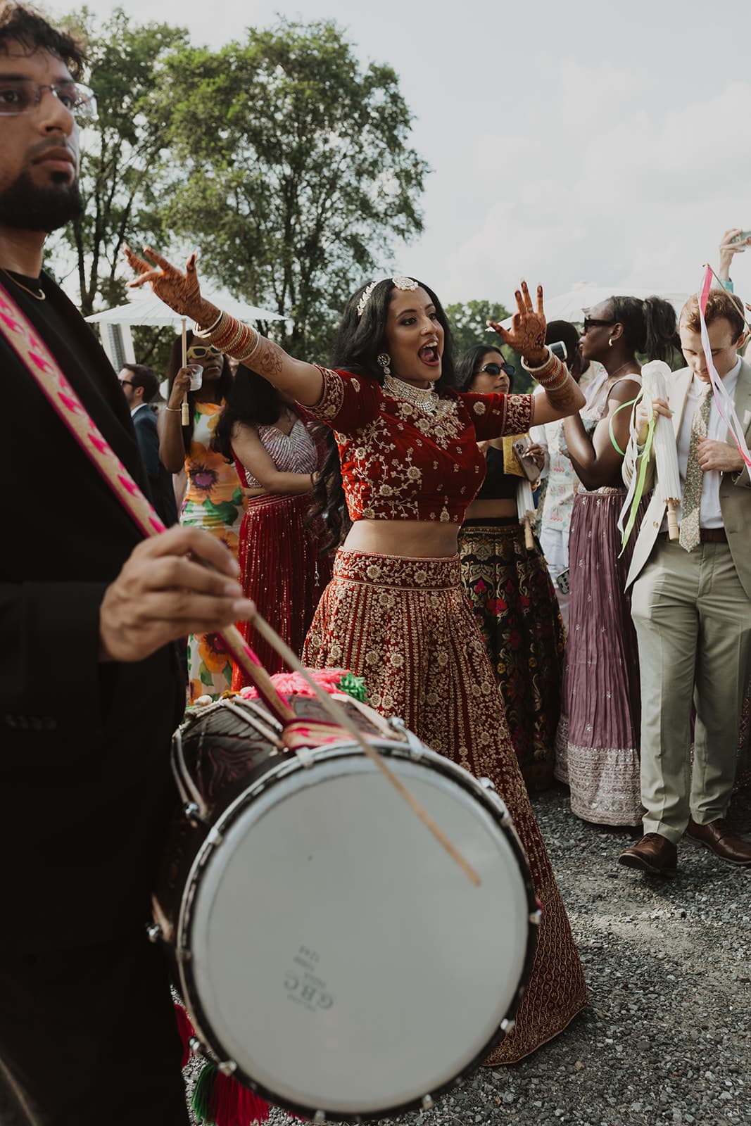 Bride dancing with dhol player