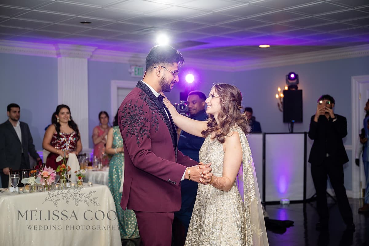 Couple sharing first dance with purple uplighting