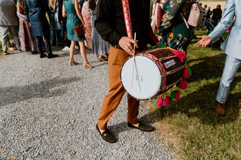 Dhol player during outdoor baraat procession