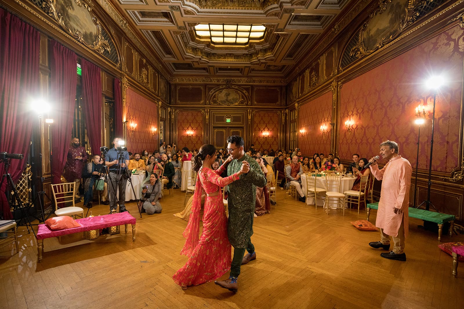 Couple dancing at sangeet in ornate ballroom